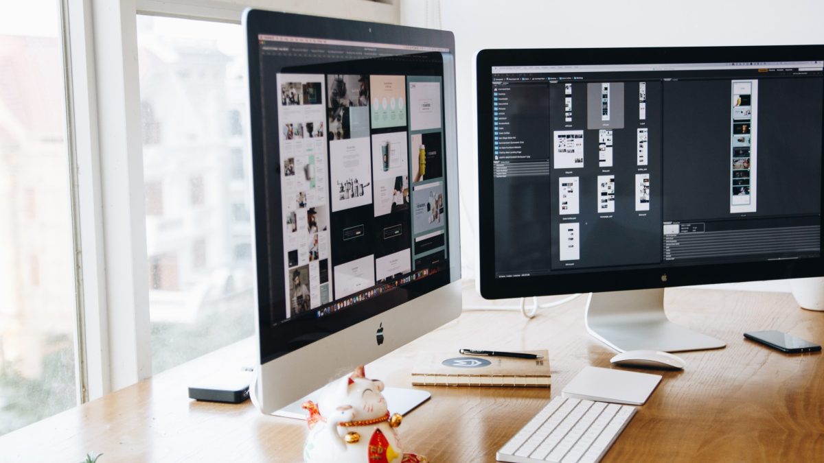 Silver Imac on Top of Brown Wooden Table