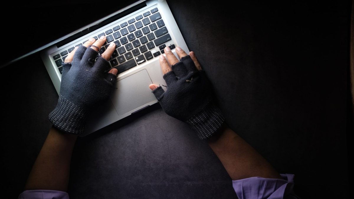 person in black long sleeve shirt using macbook pro